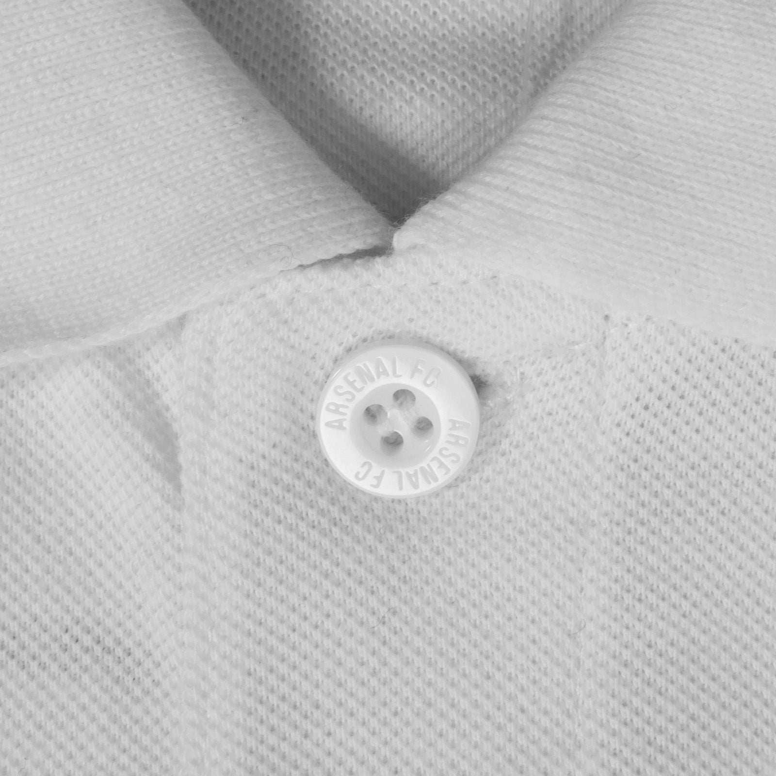 Arsenal polo shirt for adults in white featuring the club crest and Champions 2026 graphic to the chest