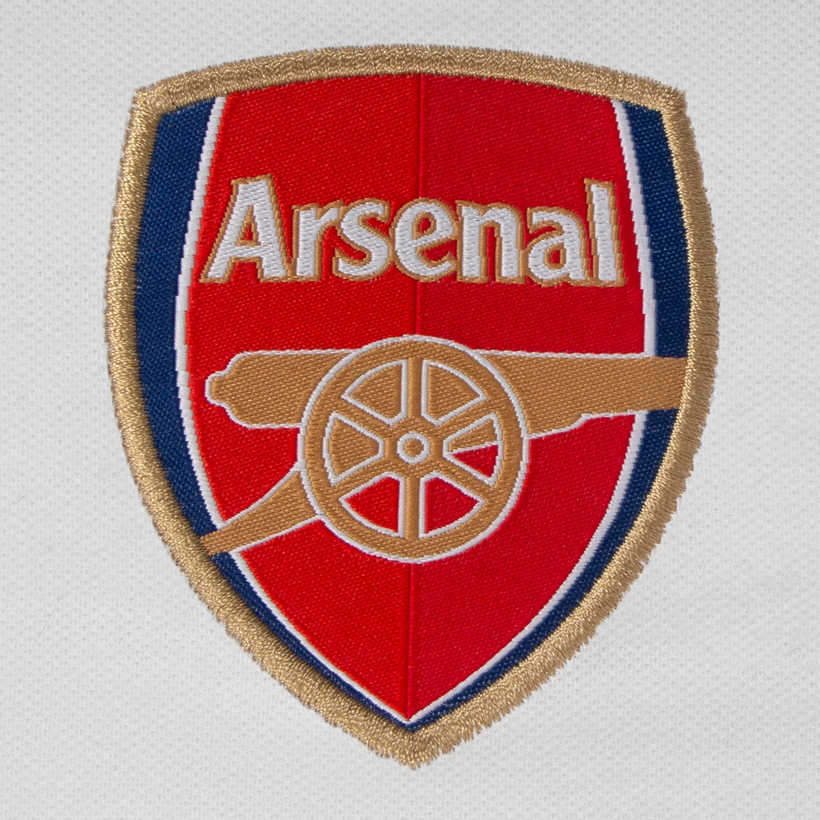 Arsenal polo shirt for adults in white featuring the club crest and Champions 2026 graphic to the chest