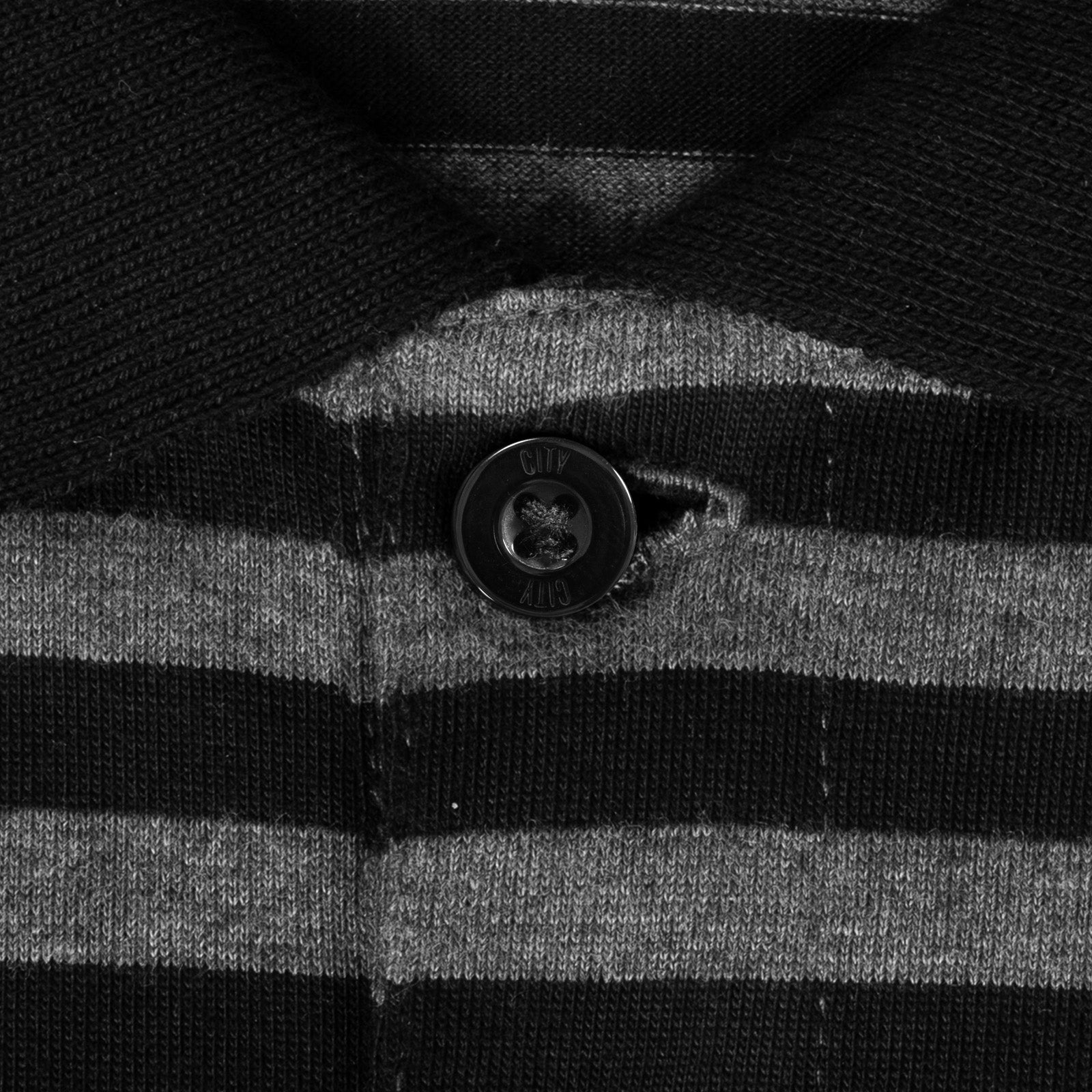 Man City long sleeve polo shirt for kids in black & grey with club crest to chest.