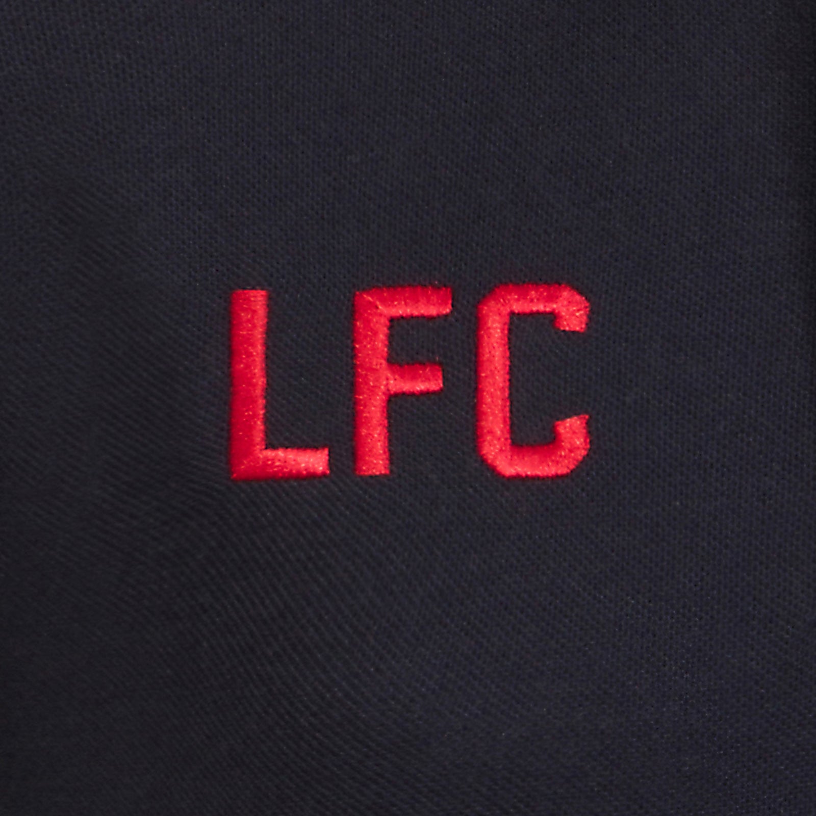Liverpool kids polo shirt in black with LFC badge and Liverpool FC text to chest.