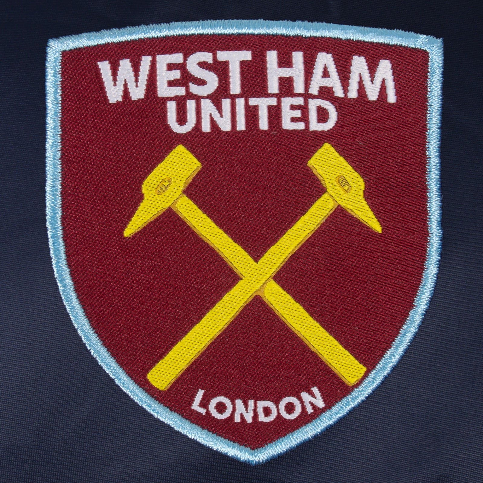 West Ham kids retro track jacket in navy blue with club crest to chest.