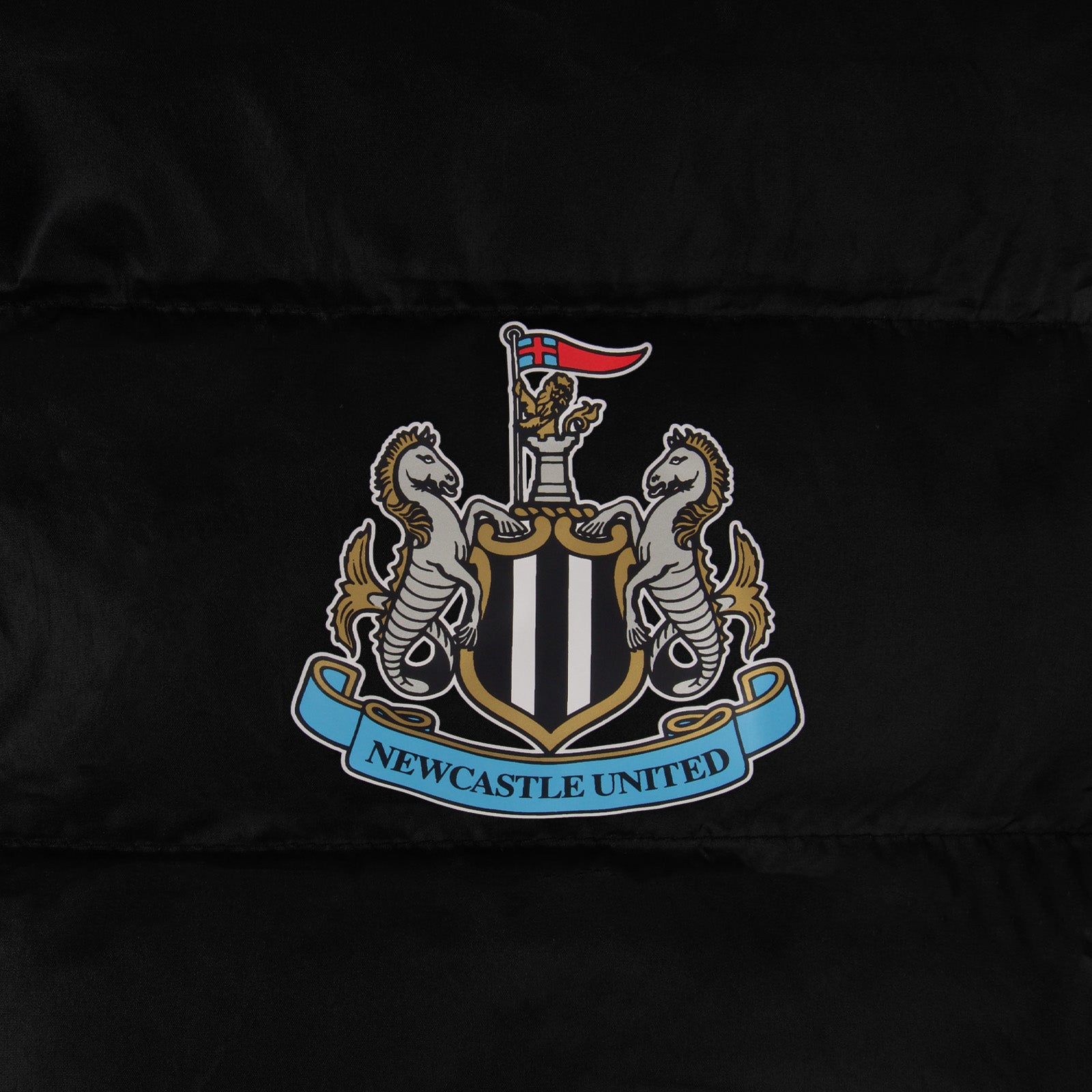 Newcastle United kids quilted jacket in black with club crest to chest.