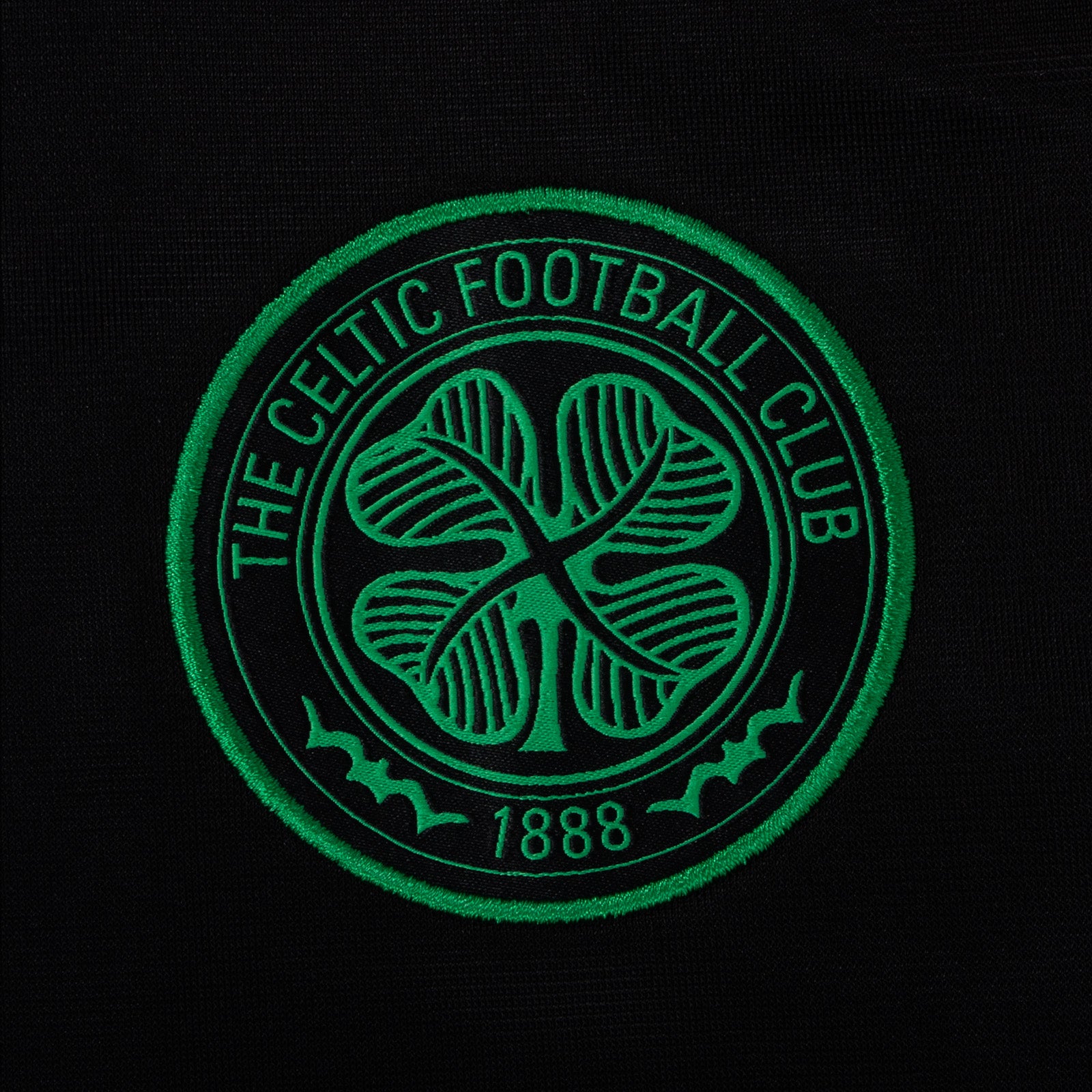 Celtic kids taped tracksuit in black with club crest and text to both top & pants