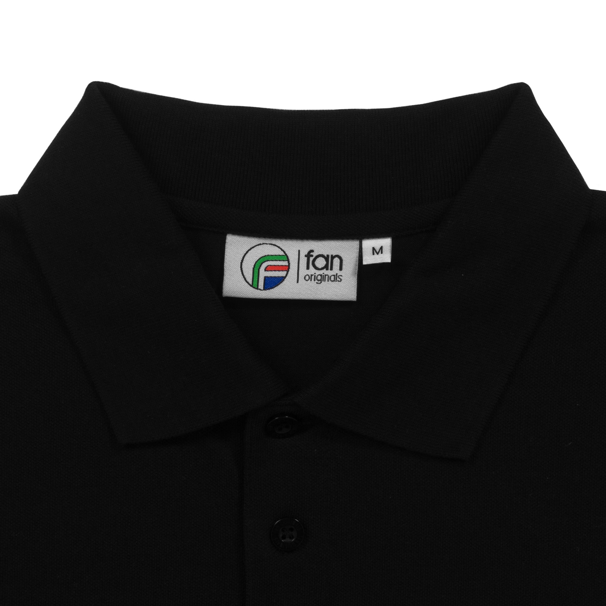 Leeds retro polo shirt in black with a smiley embroidered crest applique patch to chest