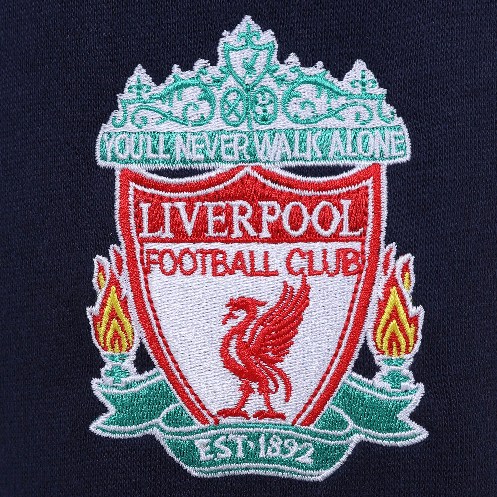 Liverpool kids tracksuit in navy blue with club crest to chest and left thigh