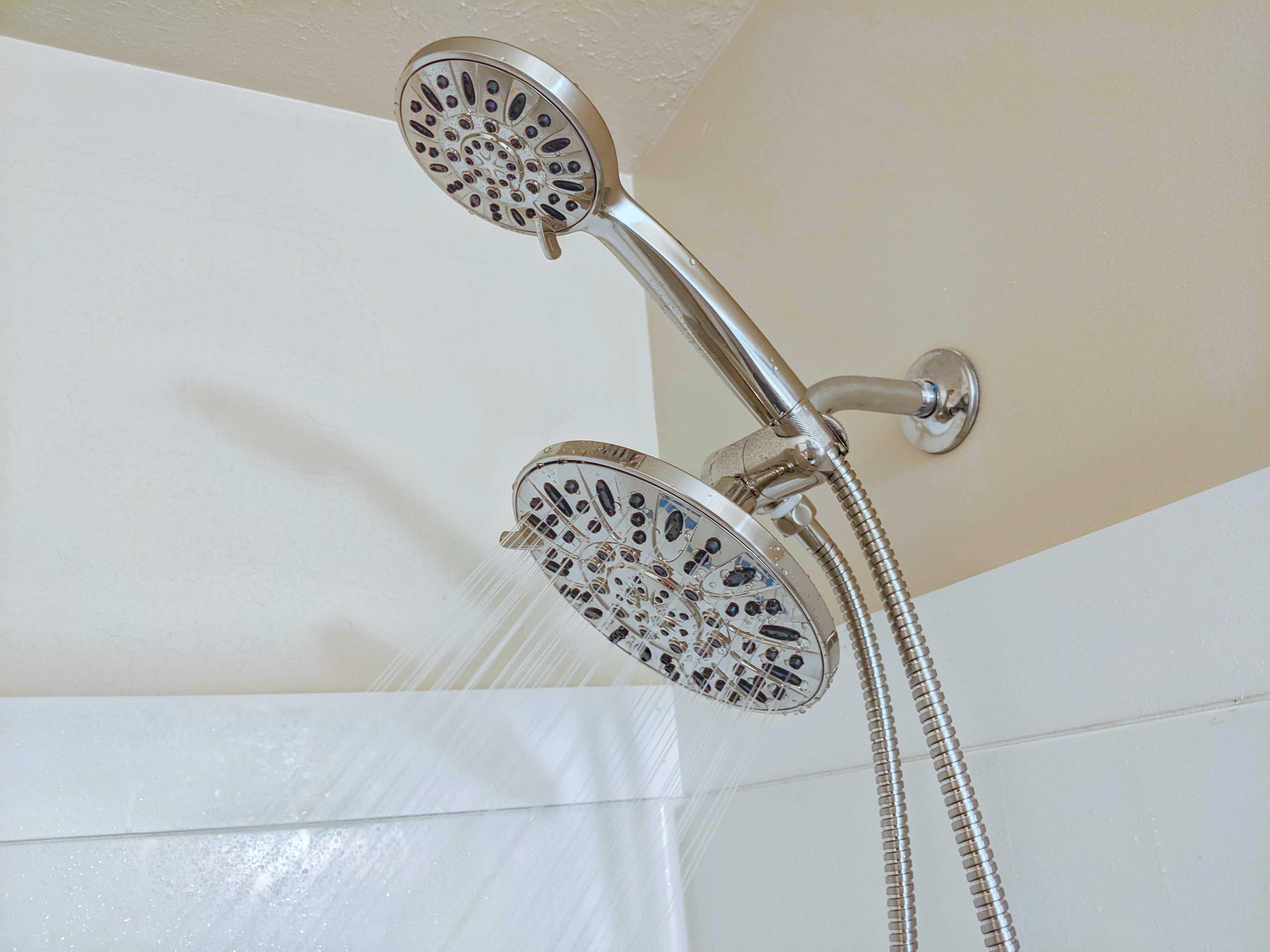 The Aquadance showerhead features a fixed rainfall showerhead and a removable spray showerhead.