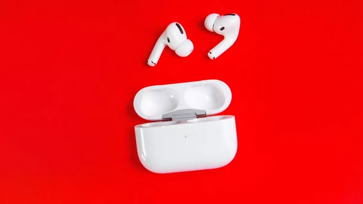 white AirPods Pro outside of open case against red background
