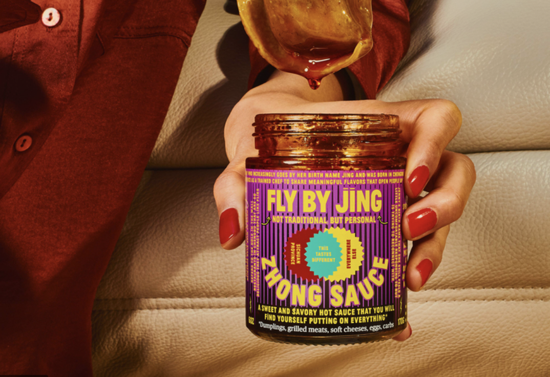 bottle of Zhong sauce in hand