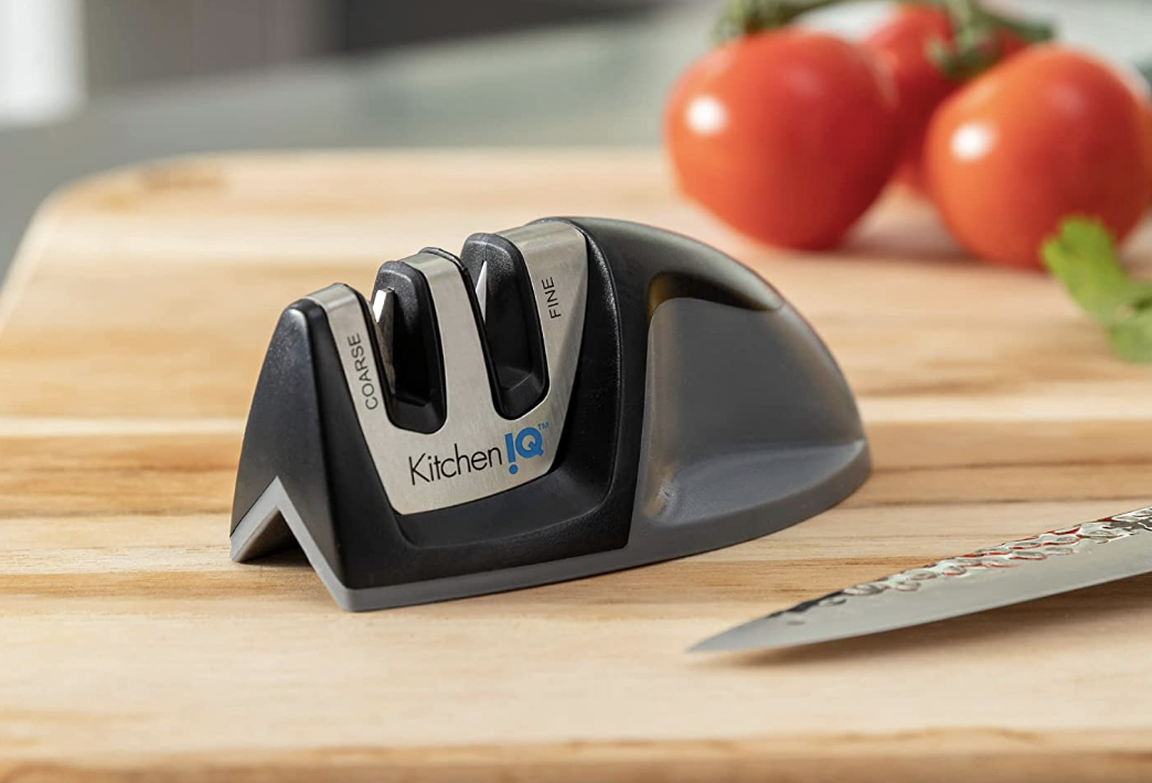 sharpening machine on cutting board with knife