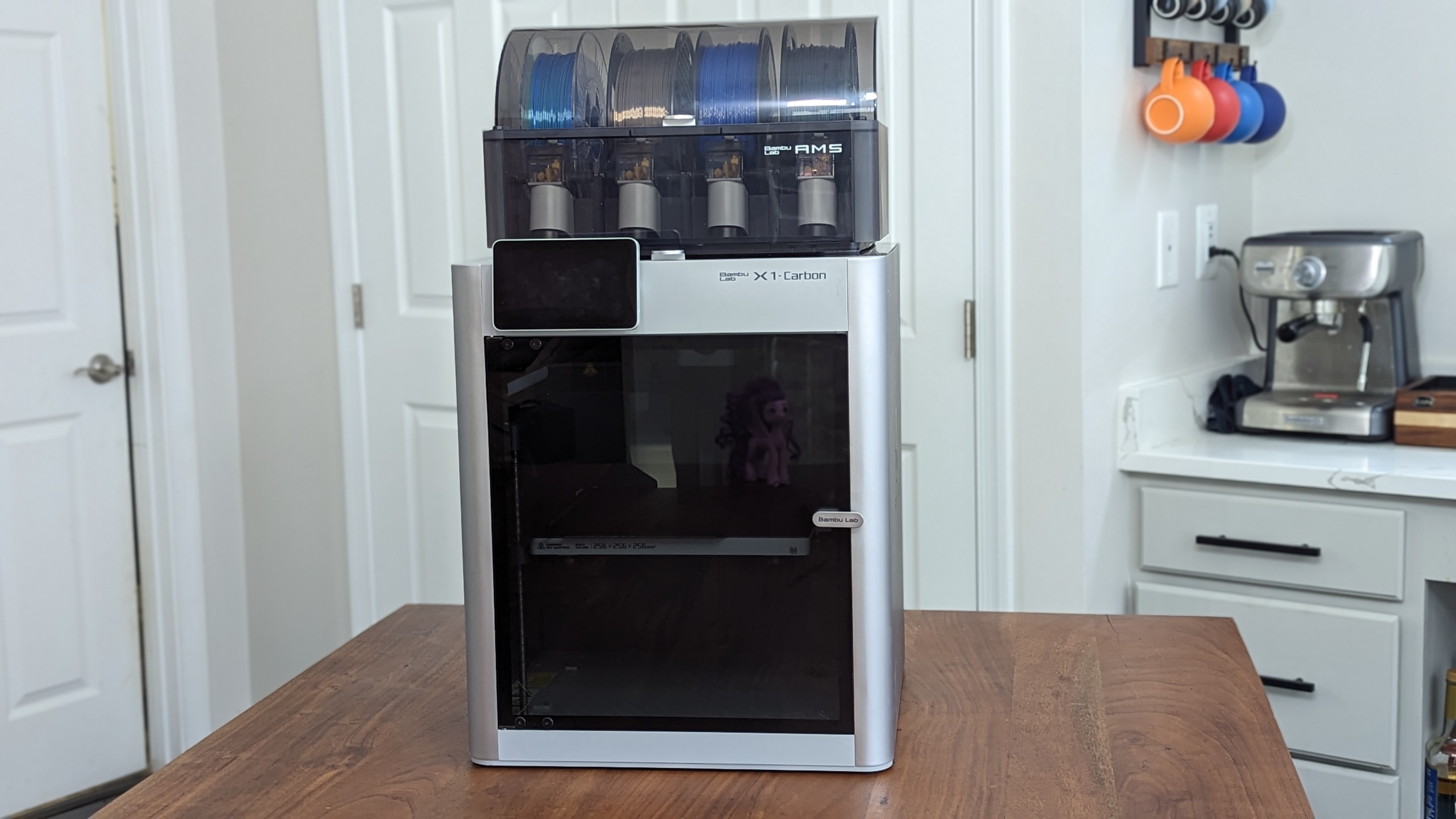 Silver 3D printer on a wood surface