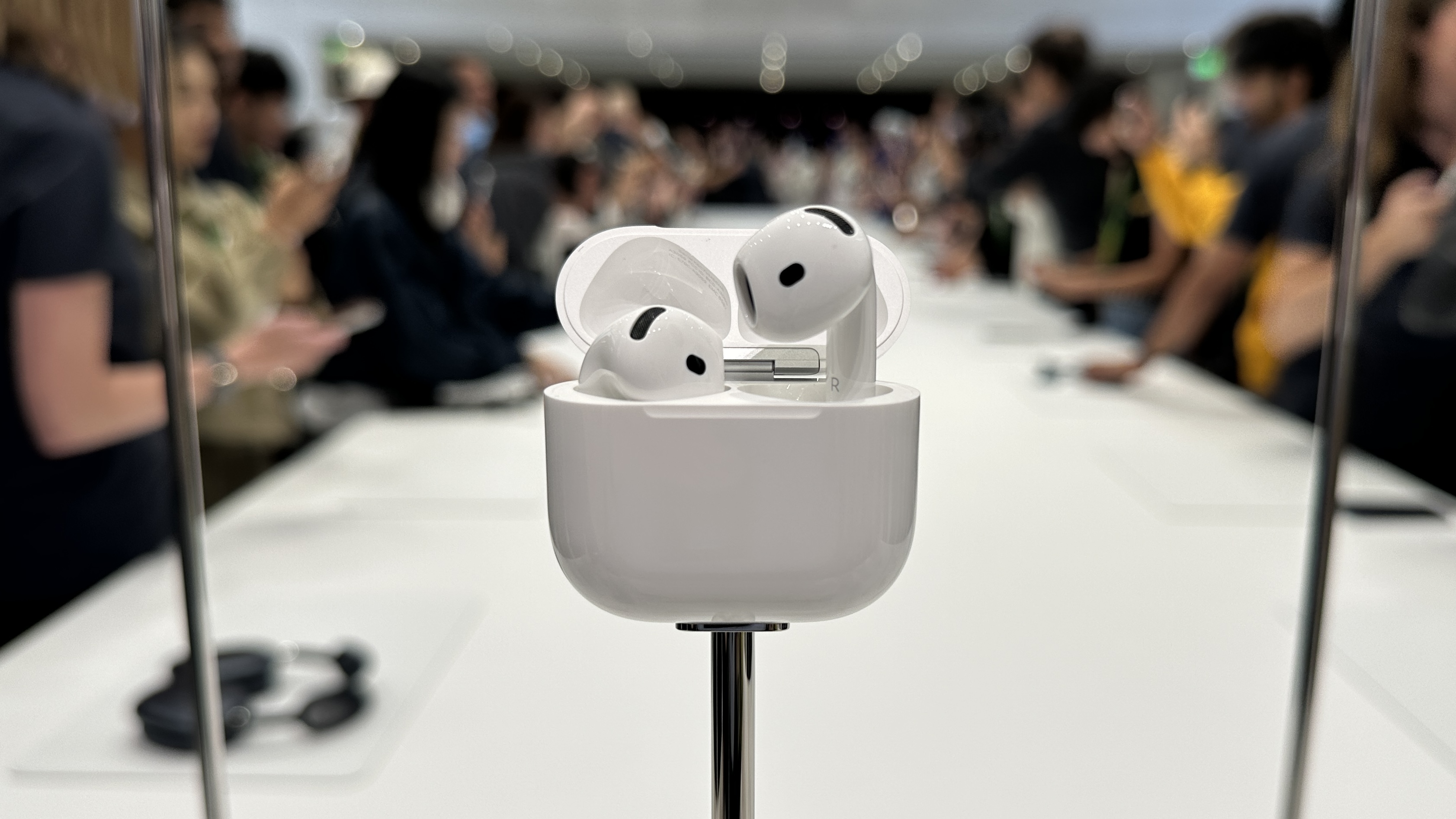The Apple AirPods 4 on a display table at the 2024 Apple Event.