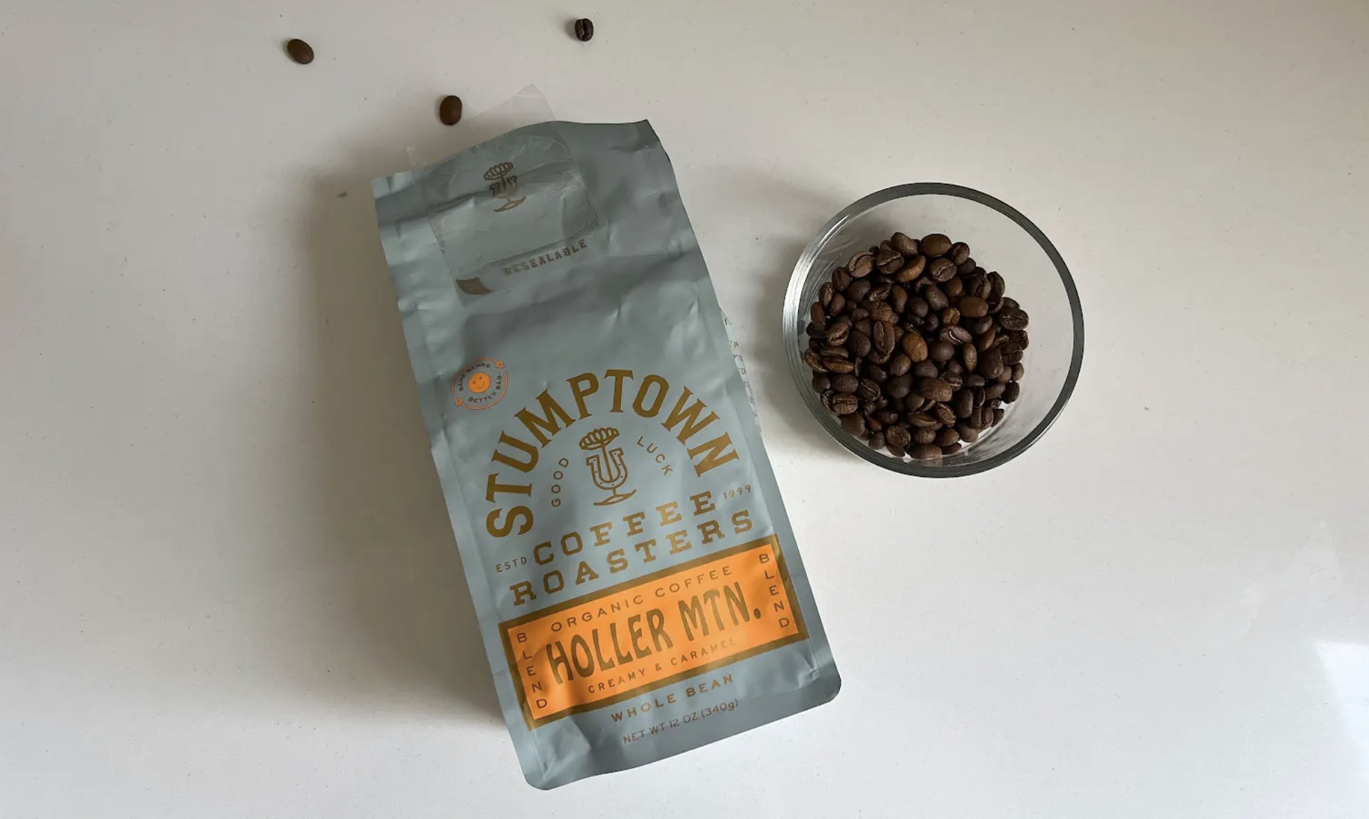 stumptown coffee bag lies next to dish of beans