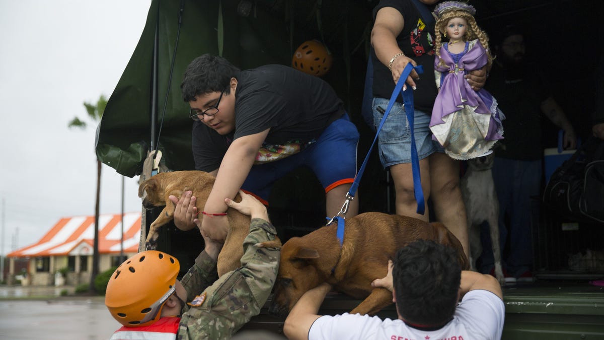 Texas Army National Guard members help families who were flooded out of their homes.