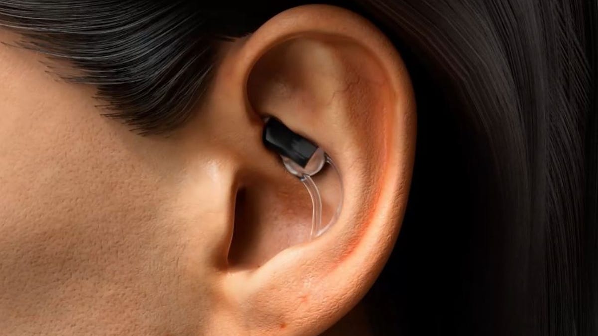 An in-ear wearable sitting near the top of someone's outer ear