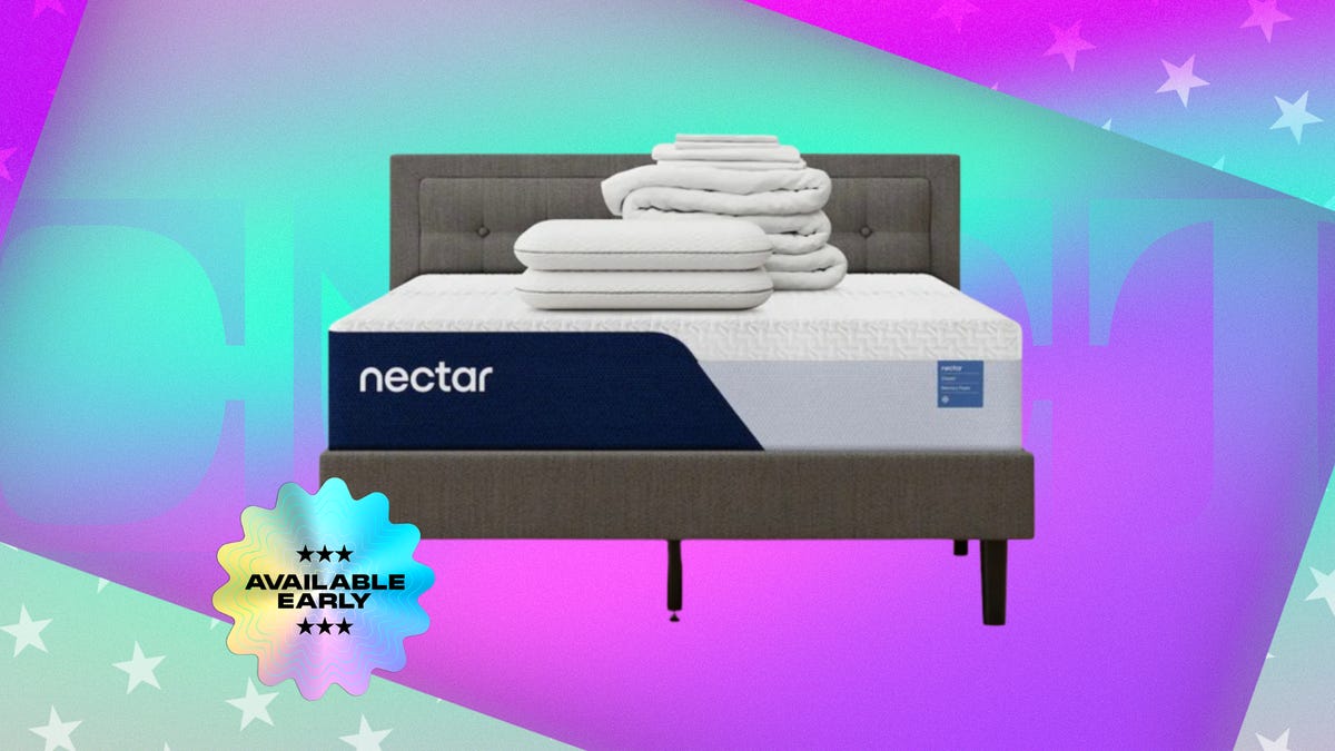 White mattress with two pillows, duvet on top of wooden bed frame. Background: cyan and purple gradient. Foreground: flower-shaped sticker with "available now" text in all caps.