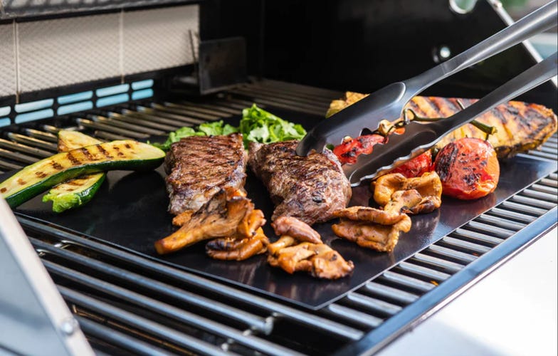grill mat on grill with meats and veggies