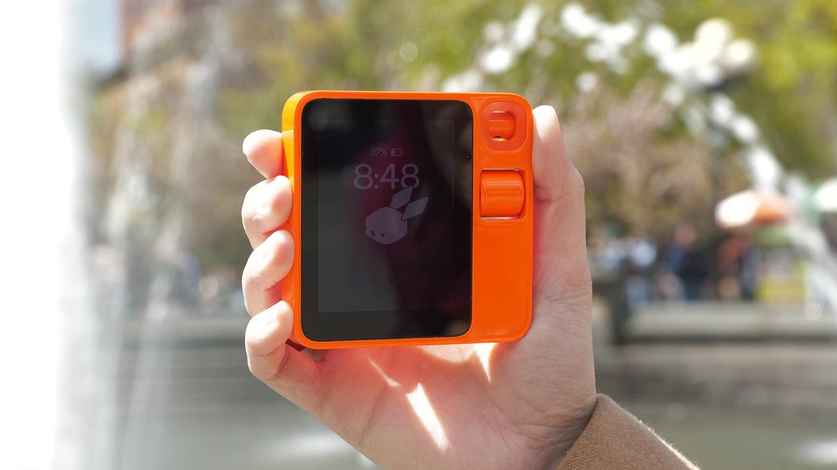 Hand holding the Rabbit R1