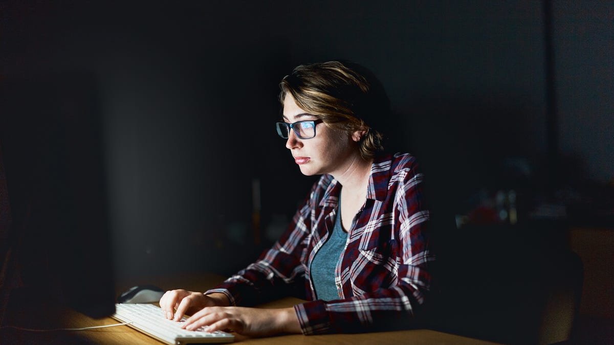 An image of a woman working at a computer.