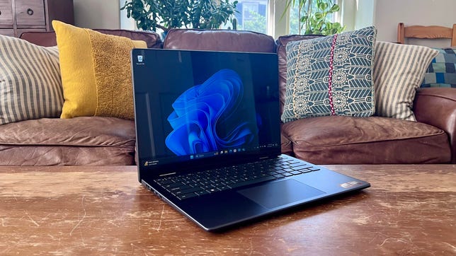 Dell Inspiron 14 2-in-1 7445 on a coffee table in front of a couch