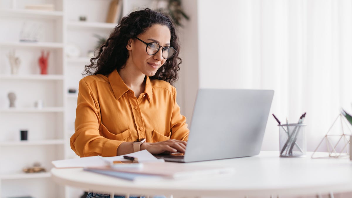Woman working on a laptop.