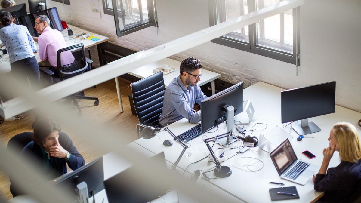 Programmers using computers at creative office