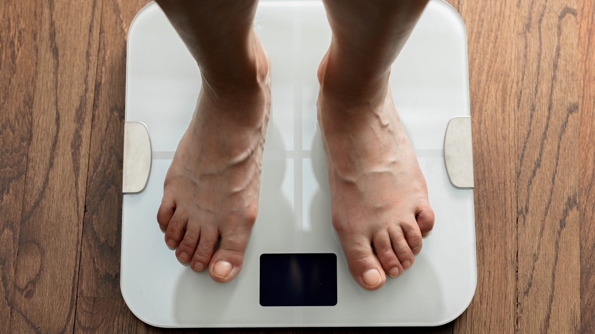 Top view of two feet on a scale