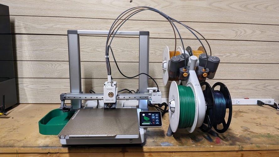 The A1 3D printer with filament rolls on the the AMS next to it