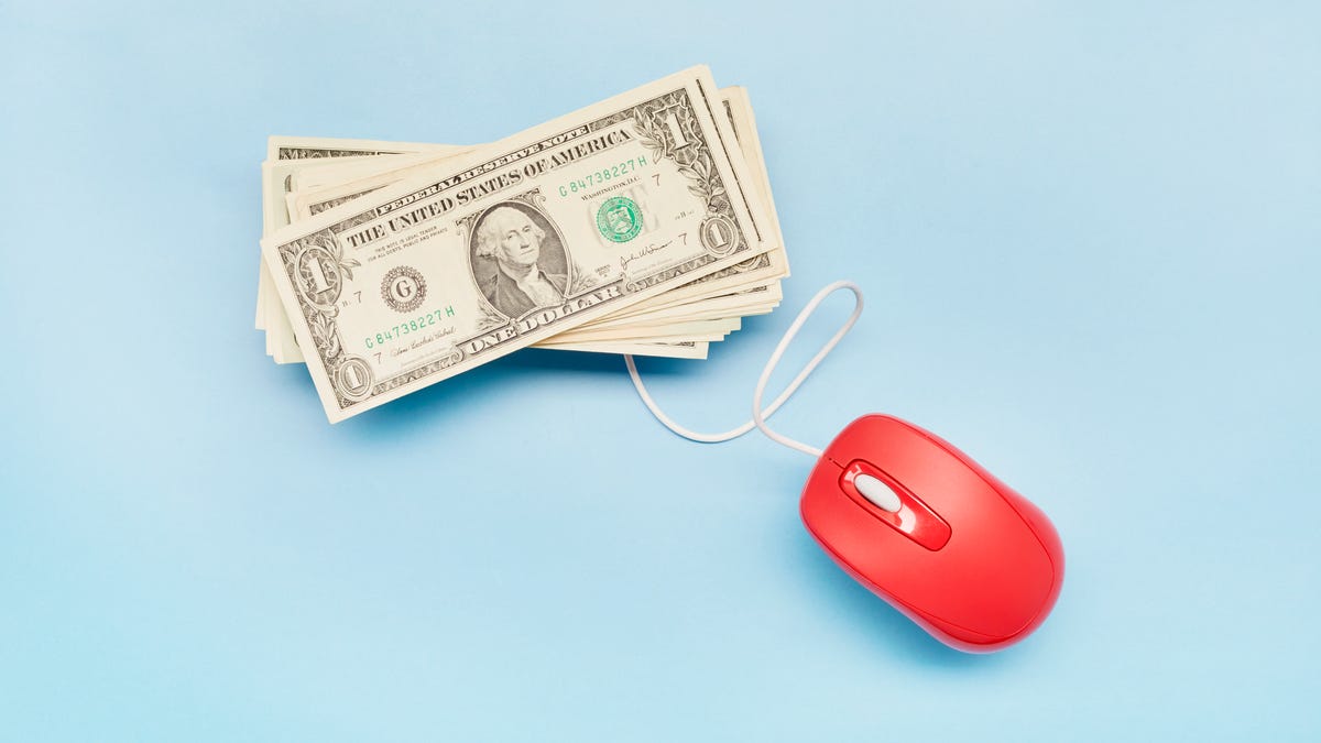 stack of cash connected to computer mouse