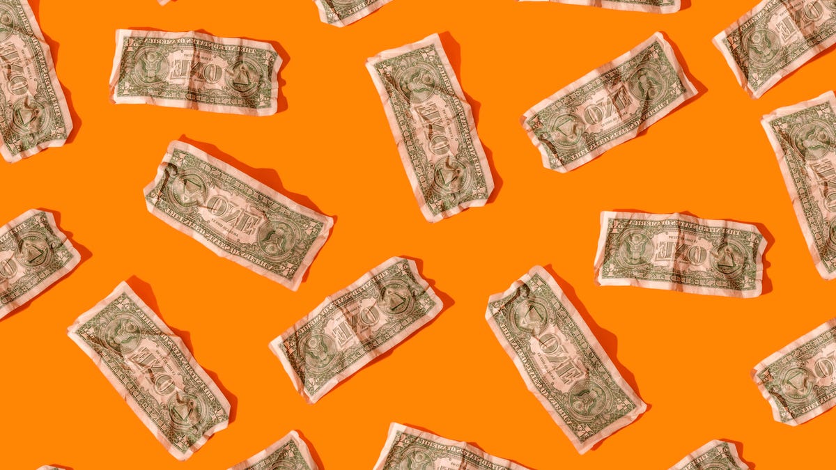 Dollar bills on an orange background