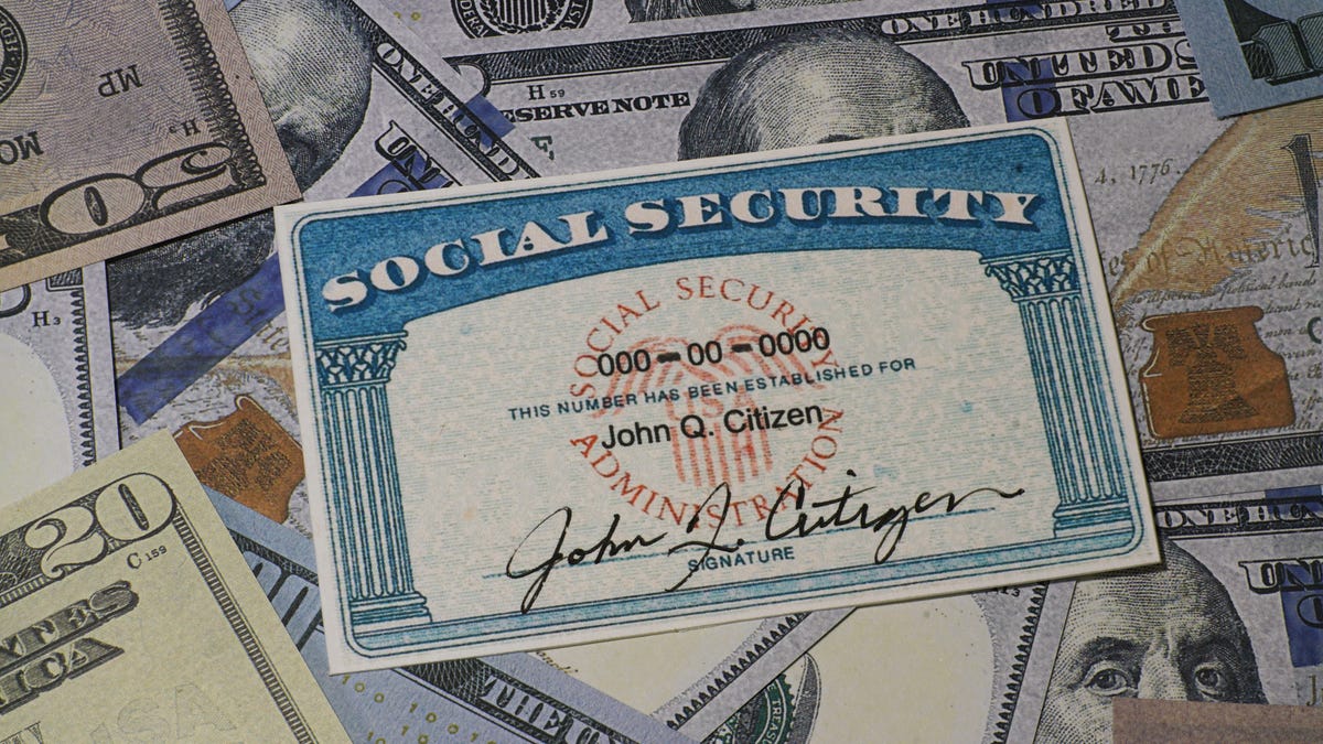 a photo of a Social Security card on top of an assorted collection of US paper money bills
