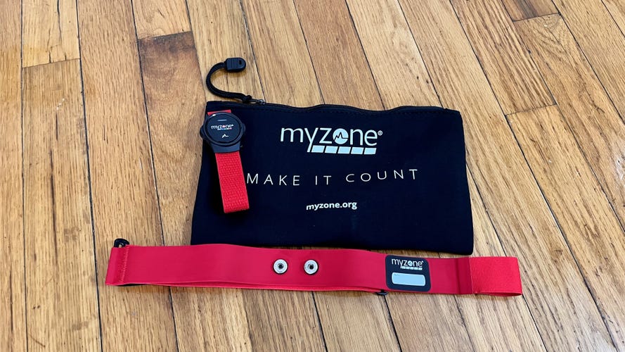 MyZone MZ Switch heart rate monitor on a wood floor