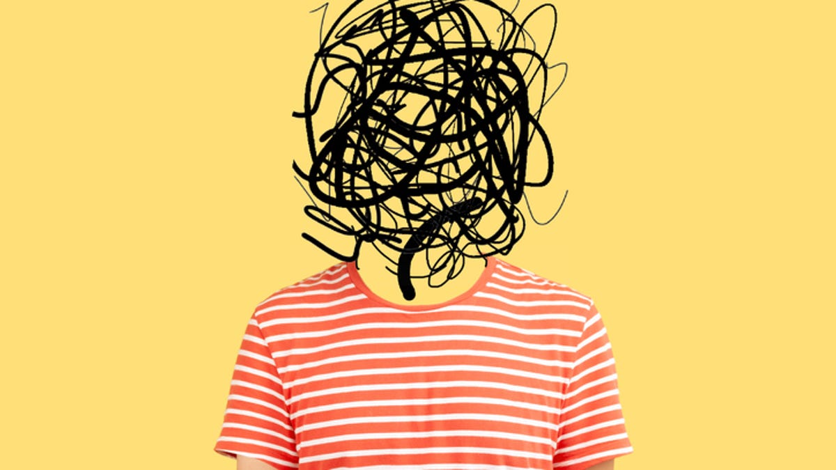 Man standing in front of a yellow background with scribbles where his head should be