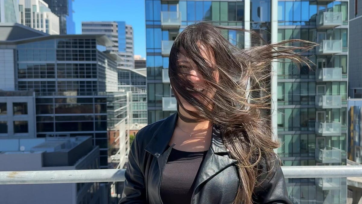 An iPhone 16 Pro Slow Motion video images shows a woman with hair in front of her face.