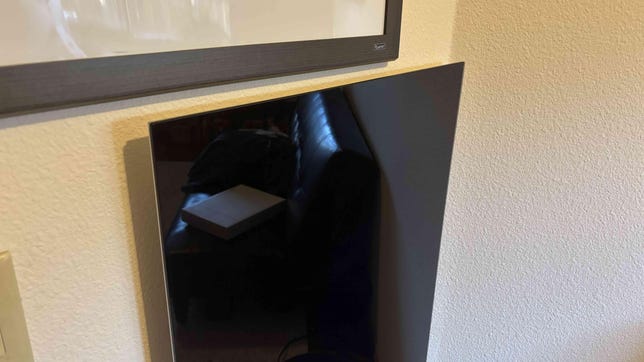 Black radiant heater on a white wall.