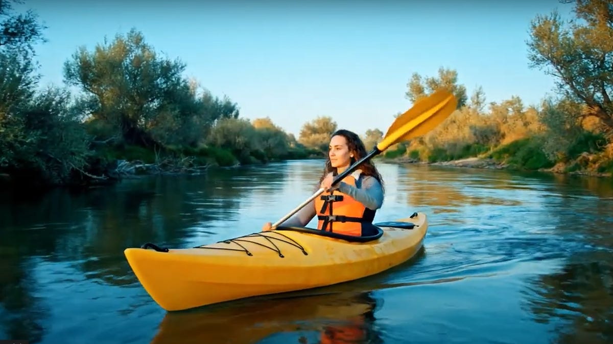 AI-generated image of a woman paddling a kayak on a river