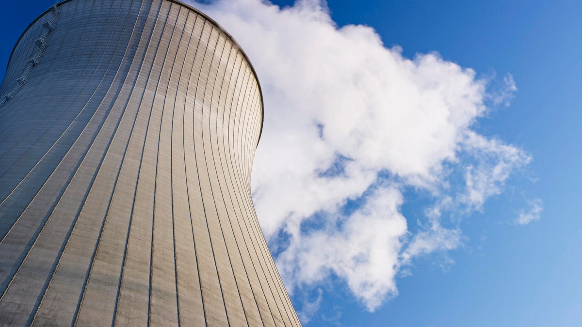 Photo shows a nuclear plant against a cloudy sky.