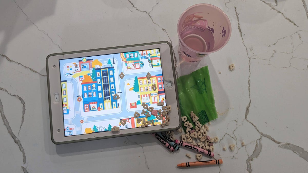 An iPad in a tough case with cereal spilled on it