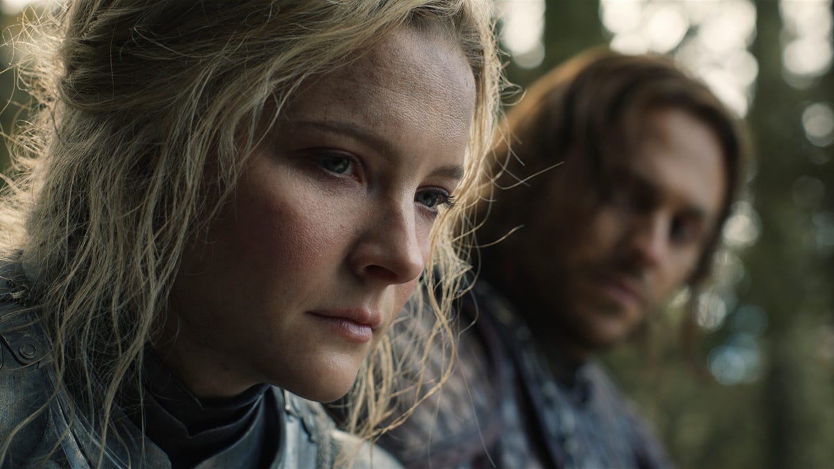 Close up of young Galadriel looking pensively down out in the woods