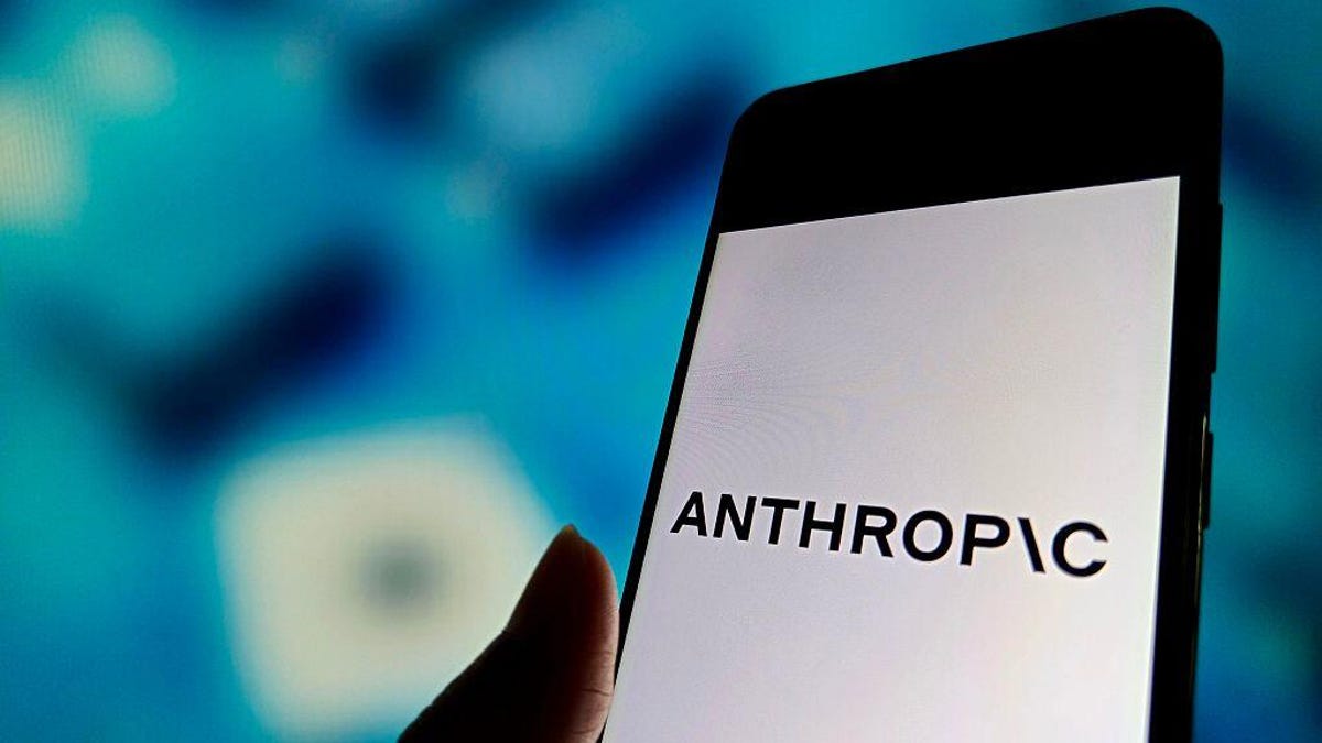 Anthropic logo on a phone in front of a blue background