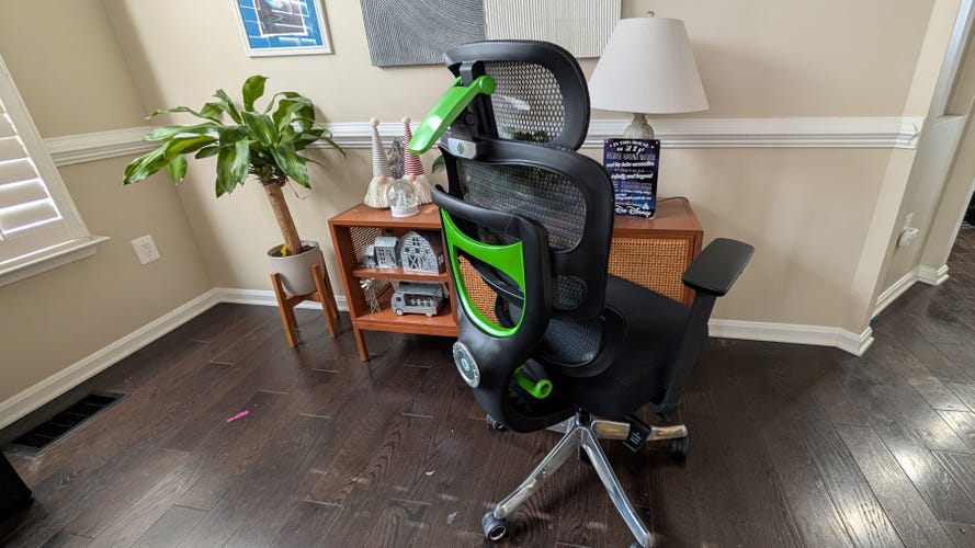 A black and green chonky chair that looks like a gaming chair