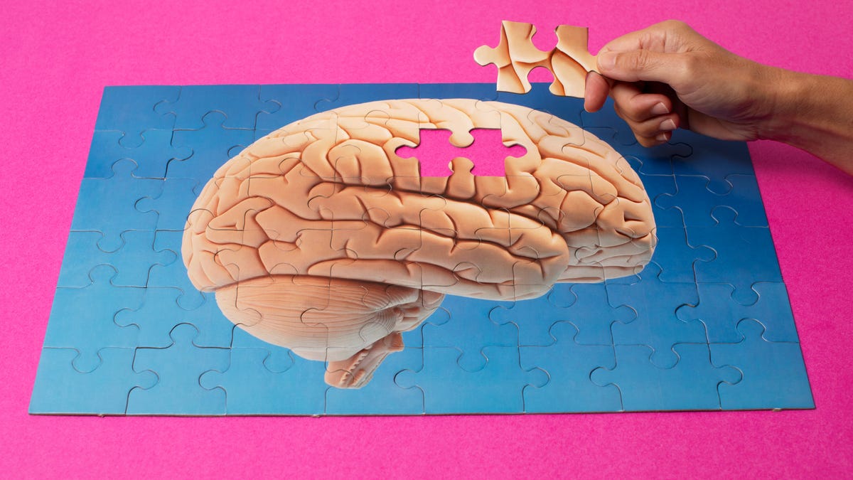 A nearly-completed puzzle of a brain with one piece missing.