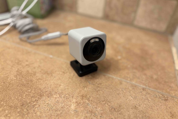 A Wyze cam on a stone table. 