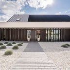 A house with solar panels in a desert setting.