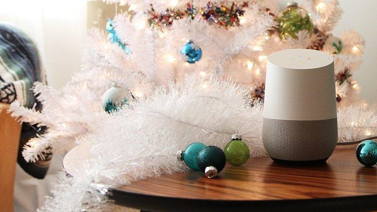 Google Home in front of a Christmas tree