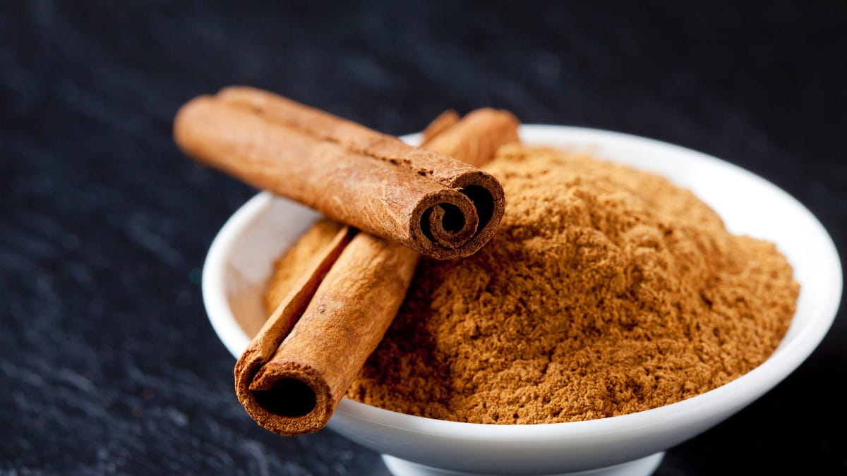 Cinnamon sticks and ground cinnamon in a bowl