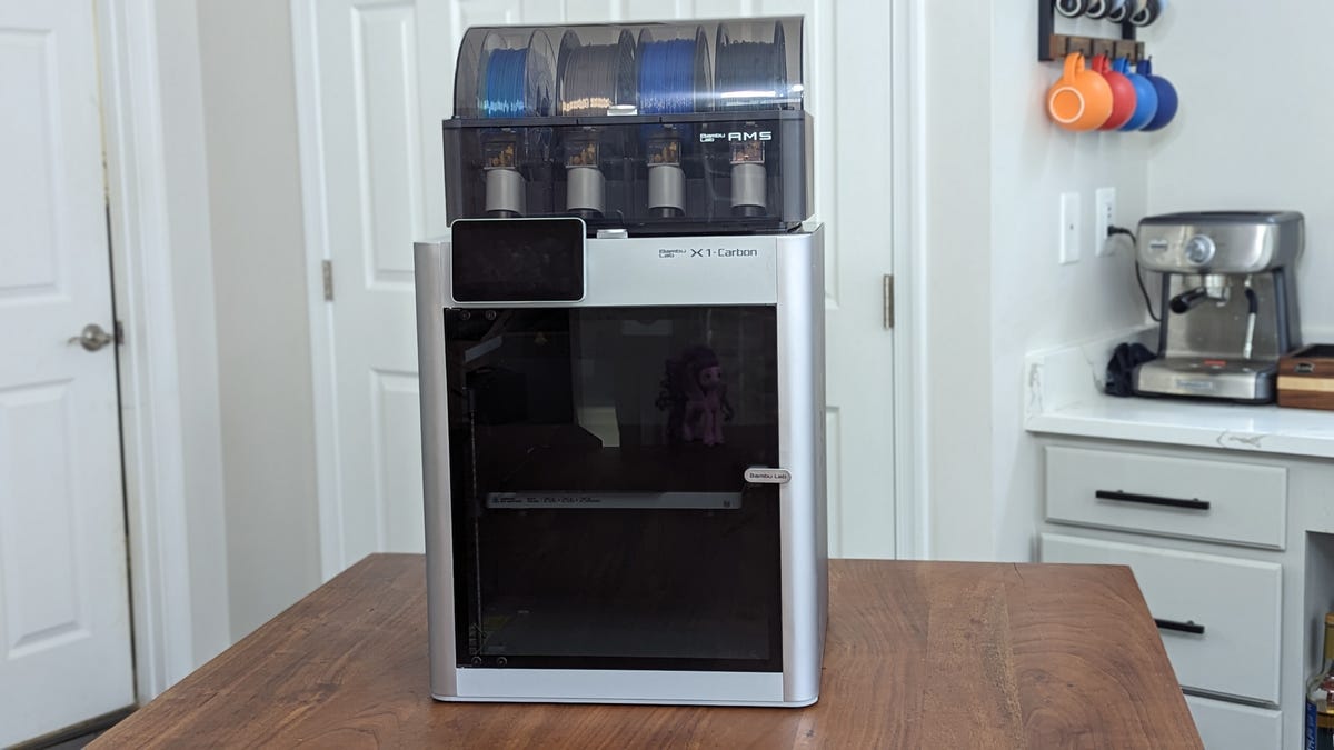 A Bambu X1 carbon 3D printer sits on a table