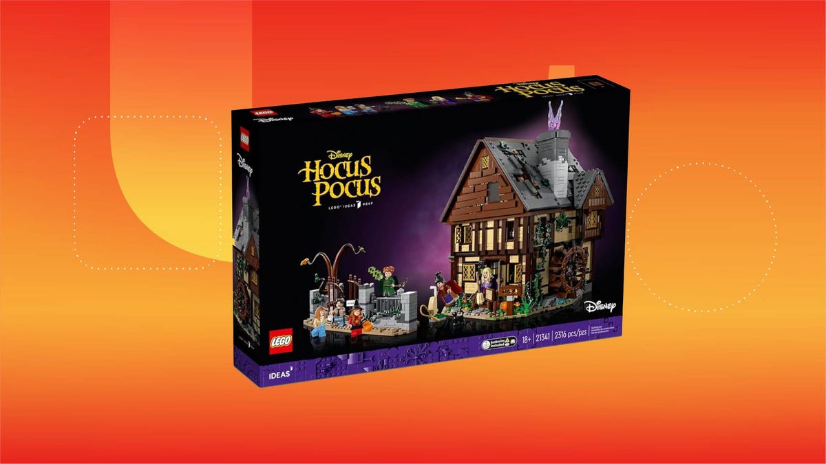 The box for the Hocus Pocus Sanderson Sister's Cottage Lego kit against an orange gradient CNET background.