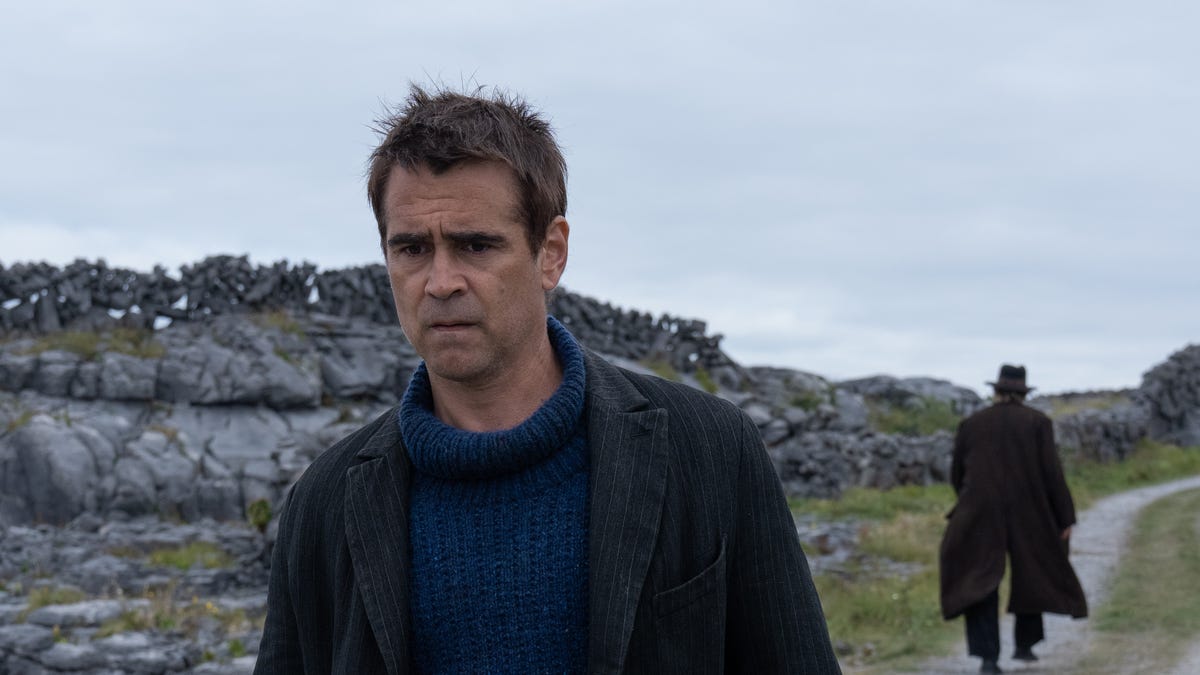 Actor Colin Farrell looks crestfallen as Brendan Gleeson walks away from him on a country road in the movie The Banshees of Inisherin.