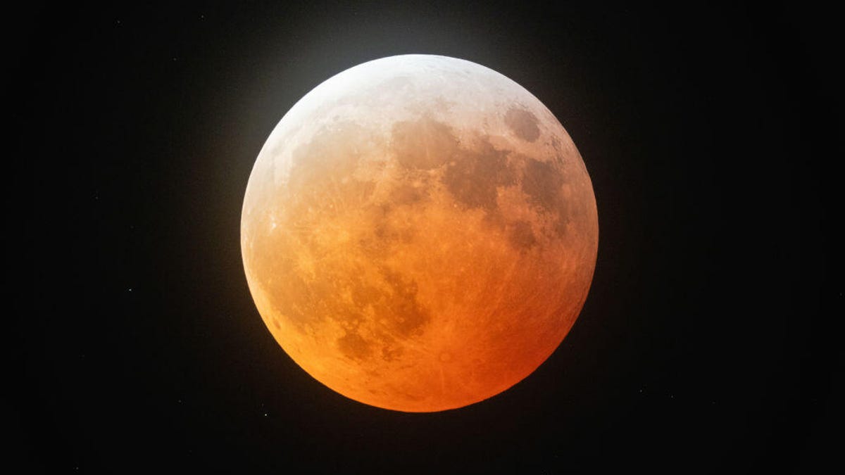 The moon has a red tinge on March 14 during the lunar eclipse.