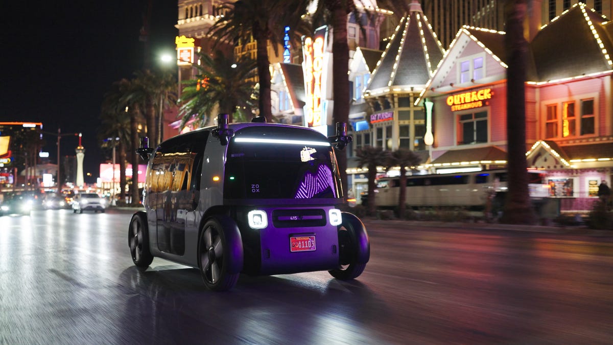 A Zoox robotaxi driving on the Las Vegas Strip at night